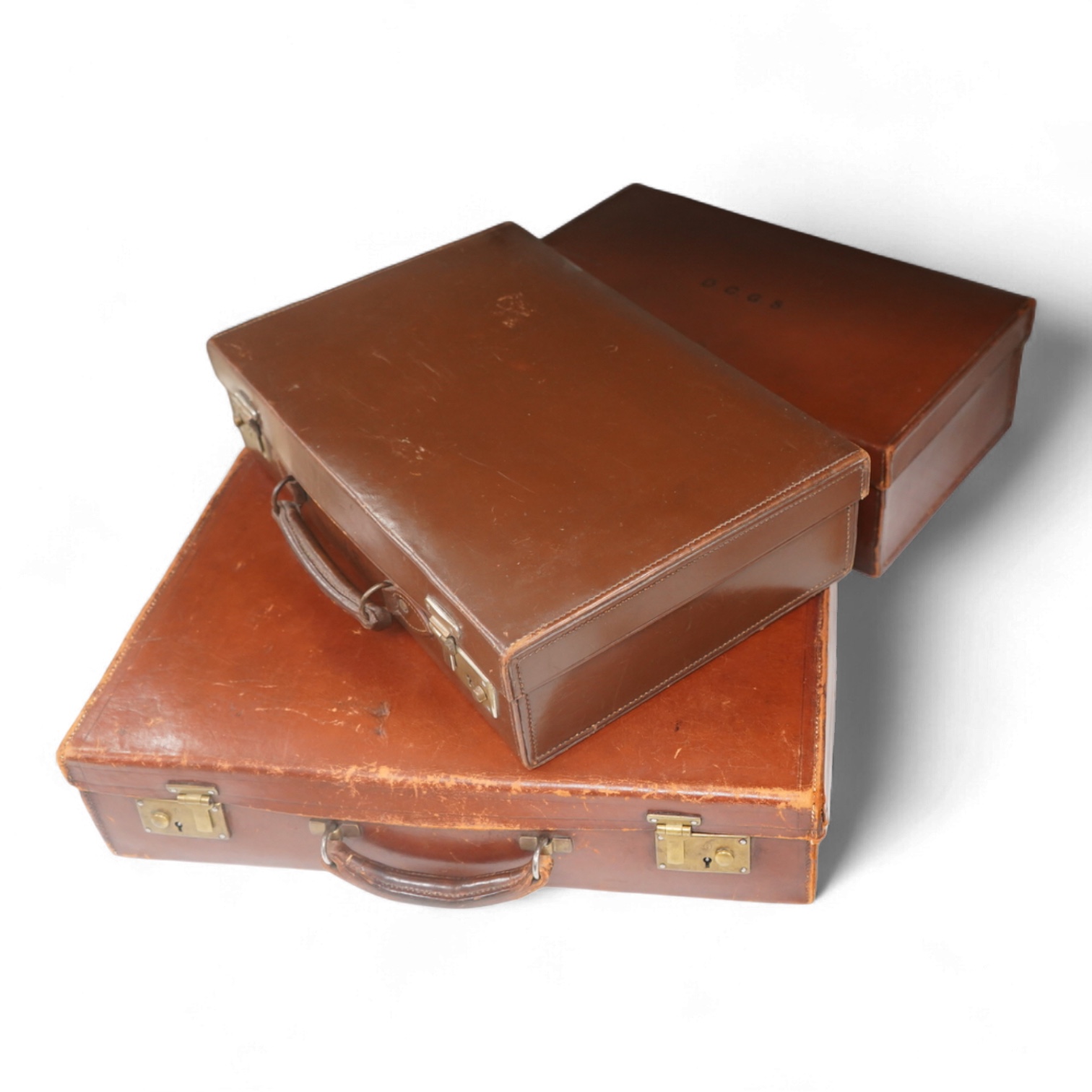 Three small vintage leather cases, largest 45cm wide